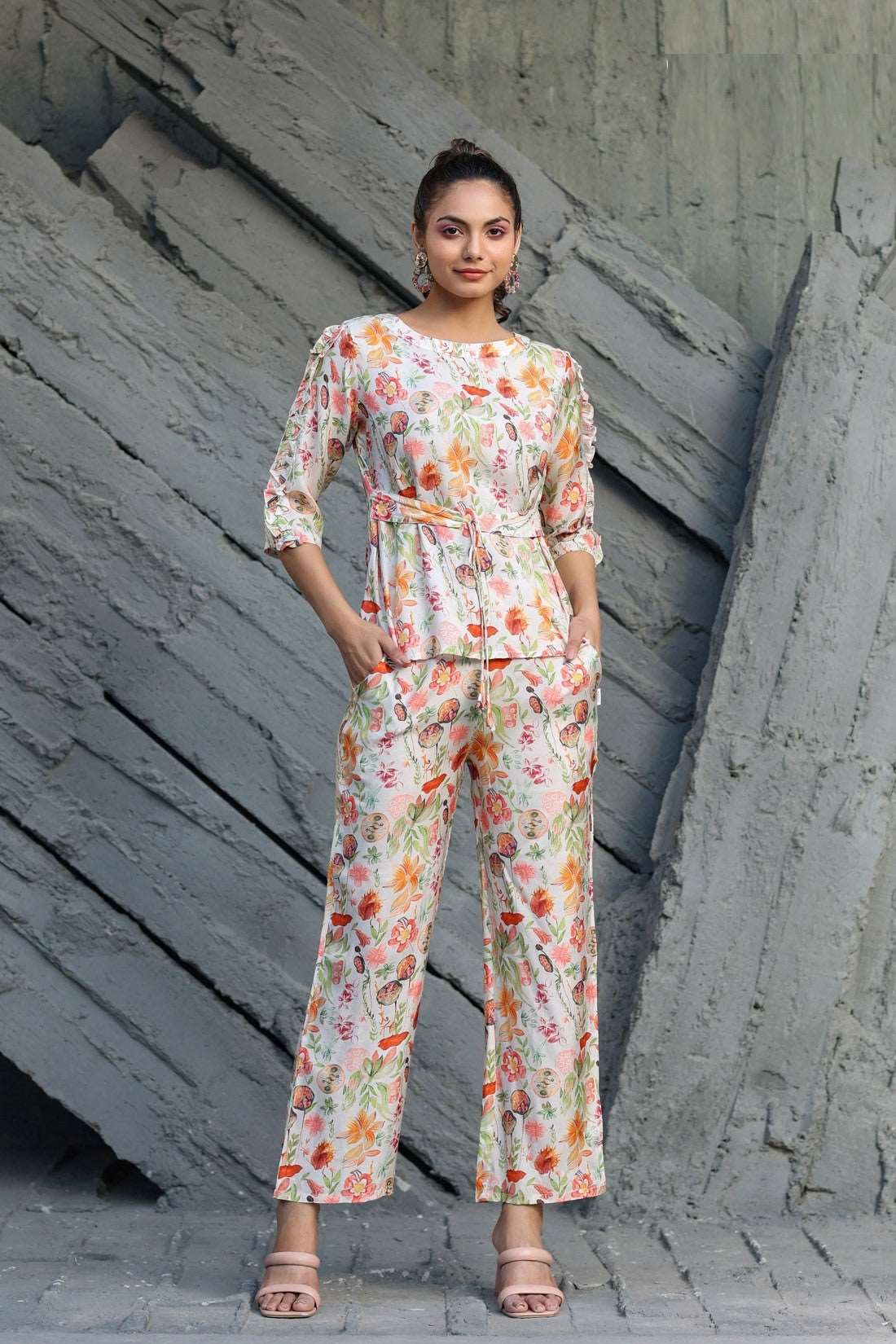 The model in the image is wearing Floral Printed Cotton Womens Co ords from Alice Milan. Crafted with the finest materials and impeccable attention to detail, the Co-ord Set looks premium, trendy, luxurious and offers unparalleled comfort. It’s a perfect clothing option for loungewear, resort wear, party wear or for an airport look. The woman in the image looks happy, and confident with her style statement putting a happy smile on her face.