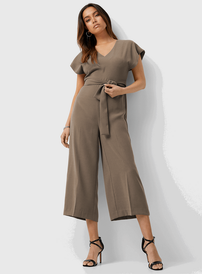 The model in the image is wearing Korean Nida Stylish Jumpsuit For Women from Alice Milan. Crafted with the finest materials and impeccable attention to detail, the Jumpsuit looks premium, trendy, luxurious and offers unparalleled comfort. It’s a perfect clothing option for loungewear, resort wear, party wear or for an airport look. The woman in the image looks happy, and confident with her style statement putting a happy smile on her face.