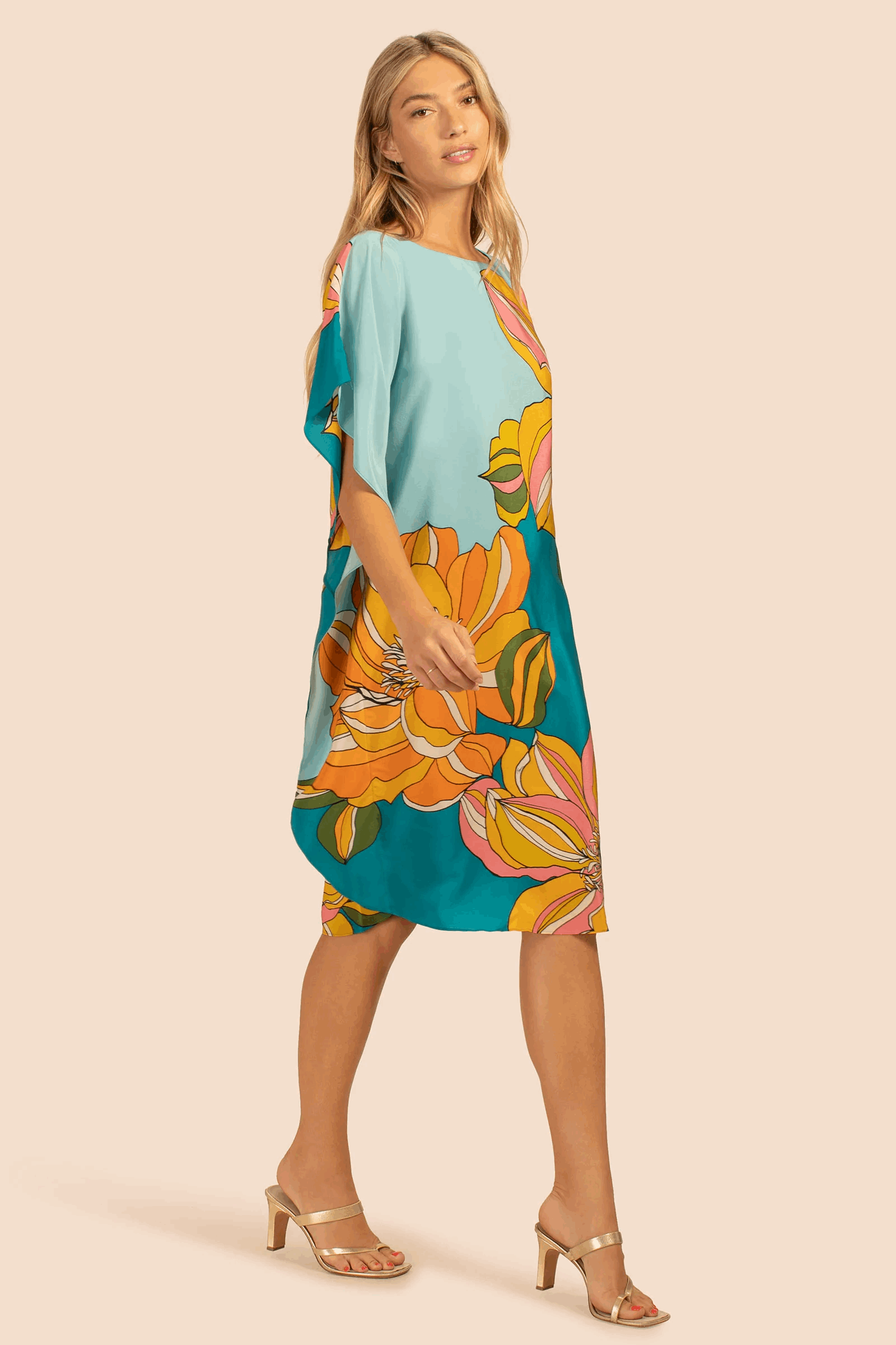 The model in the image is wearing Floral Printed Soft Silk Crepe Womens Kaftan from Alice Milan. Crafted with the finest materials and impeccable attention to detail, the Kaftan / Dress looks premium, trendy, luxurious and offers unparalleled comfort. It’s a perfect clothing option for loungewear, resort wear, party wear or for an airport look. The woman in the image looks happy, and confident with her style statement putting a happy smile on her face.