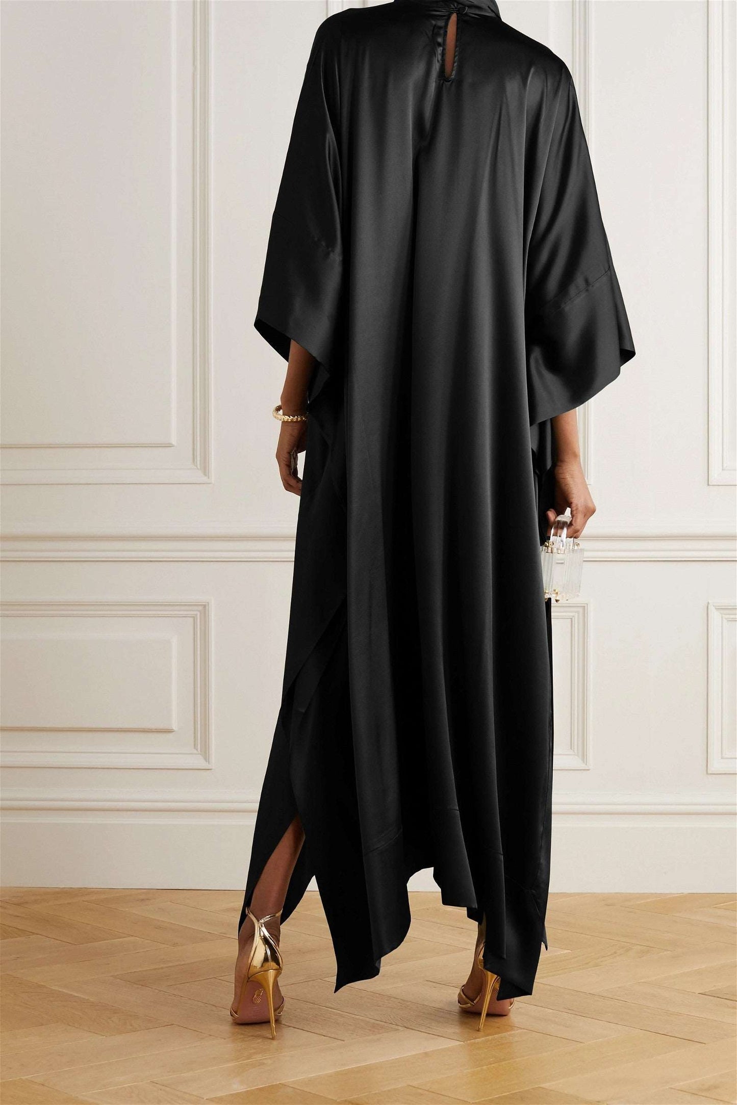 The model in the image is wearing Amazing Heavy Designer Party Wear Kaftan from Alice Milan. Crafted with the finest materials and impeccable attention to detail, the Dress looks premium, trendy, luxurious and offers unparalleled comfort. It’s a perfect clothing option for loungewear, resort wear, party wear or for an airport look. The woman in the image looks happy, and confident with her style statement putting a happy smile on her face.