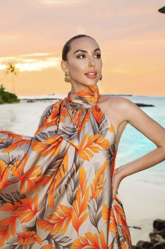 The model in the image is wearing Orange Premium Persian Silk Printed Beach Party Outfit from Alice Milan. Crafted with the finest materials and impeccable attention to detail, the Kaftan / Dress looks premium, trendy, luxurious and offers unparalleled comfort. It’s a perfect clothing option for loungewear, resort wear, party wear or for an airport look. The woman in the image looks happy, and confident with her style statement putting a happy smile on her face.