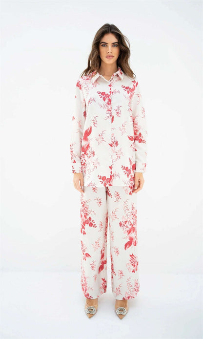 The model in the image is wearing Cherry Blossom Beach Summer Co ord Sets from Alice Milan. Crafted with the finest materials and impeccable attention to detail, the Co-ord Set looks premium, trendy, luxurious and offers unparalleled comfort. It’s a perfect clothing option for loungewear, resort wear, party wear or for an airport look. The woman in the image looks happy, and confident with her style statement putting a happy smile on her face.