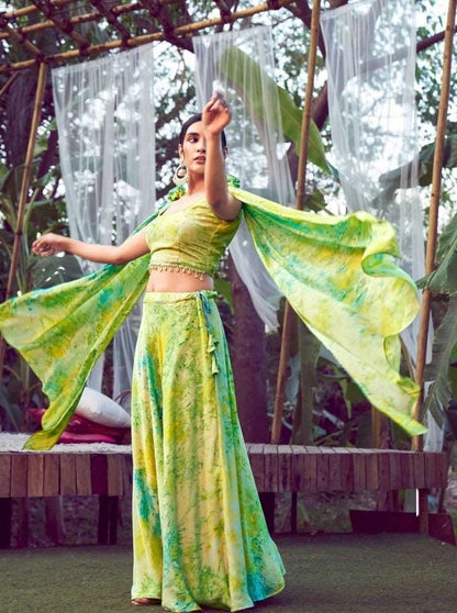 The model in the image is wearing Fluorescent Green Tie & Dye Silk Fancy Shoulder Dupatta Style Indo Western from Alice Milan. Crafted with the finest materials and impeccable attention to detail, the  looks premium, trendy, luxurious and offers unparalleled comfort. It’s a perfect clothing option for loungewear, resort wear, party wear or for an airport look. The woman in the image looks happy, and confident with her style statement putting a happy smile on her face.