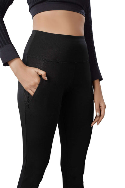 The model in the image is wearing Black Colour Polyester Solid Pattern Track Pant For Women's from Alice Milan. Crafted with the finest materials and impeccable attention to detail, the Track Pant looks premium, trendy, luxurious and offers unparalleled comfort. It’s a perfect clothing option for loungewear, resort wear, party wear or for an airport look. The woman in the image looks happy, and confident with her style statement putting a happy smile on her face.
