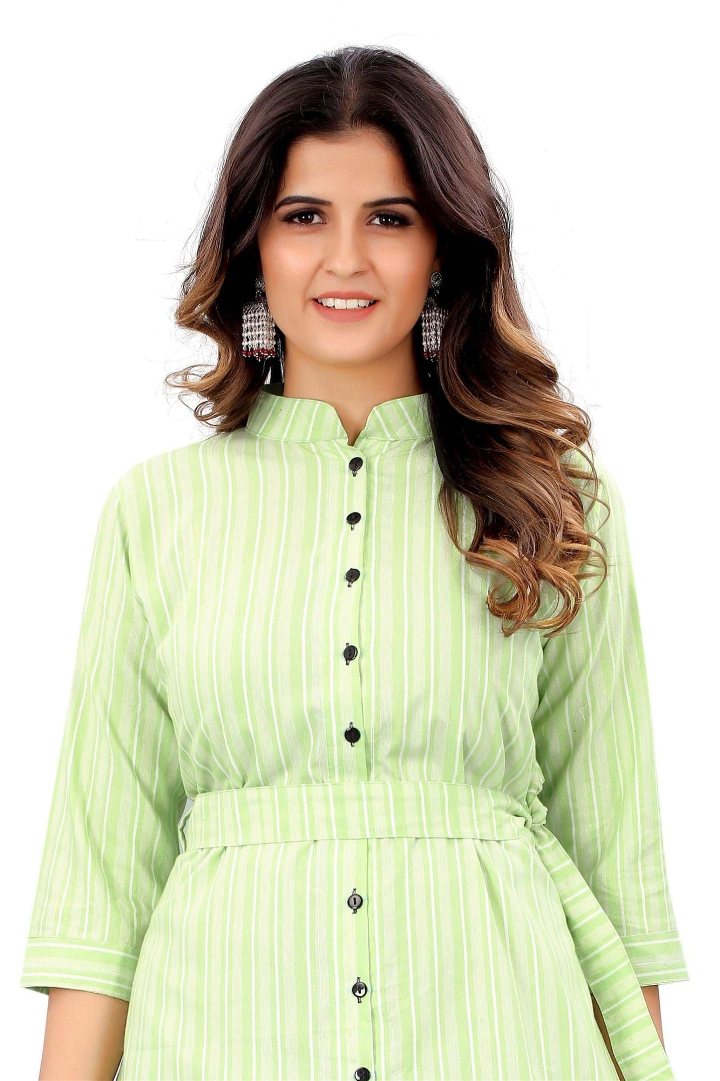 The model in the image is wearing Light Green Colour Cotton Printed Casual Wear Dress from Alice Milan. Crafted with the finest materials and impeccable attention to detail, the Dress looks premium, trendy, luxurious and offers unparalleled comfort. It’s a perfect clothing option for loungewear, resort wear, party wear or for an airport look. The woman in the image looks happy, and confident with her style statement putting a happy smile on her face.