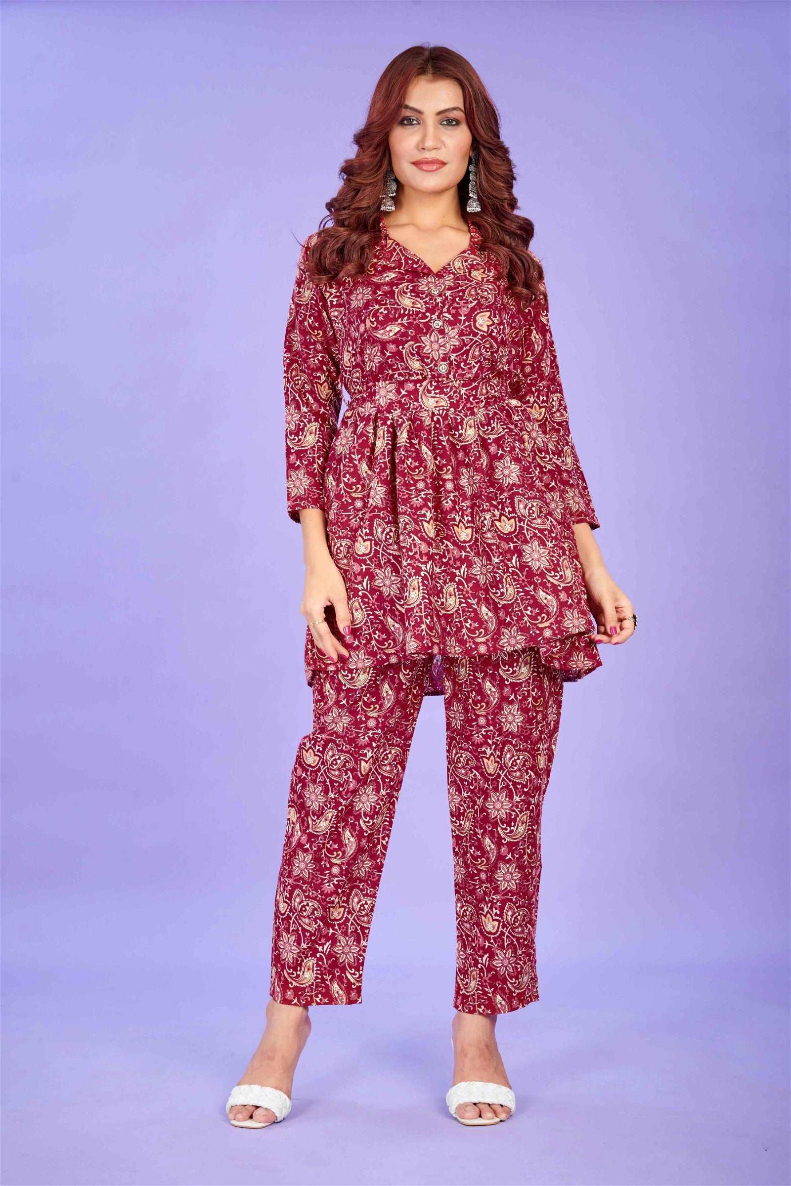 The model in the image is wearing Maroon Cotton Party Wear Co-ords Set from Alice Milan. Crafted with the finest materials and impeccable attention to detail, the  looks premium, trendy, luxurious and offers unparalleled comfort. It’s a perfect clothing option for loungewear, resort wear, party wear or for an airport look. The woman in the image looks happy, and confident with her style statement putting a happy smile on her face.