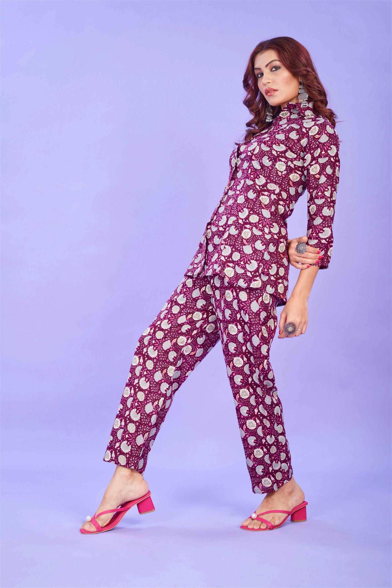 The model in the image is wearing Cotton Printed Party Red Co ord Set from Alice Milan. Crafted with the finest materials and impeccable attention to detail, the  looks premium, trendy, luxurious and offers unparalleled comfort. It’s a perfect clothing option for loungewear, resort wear, party wear or for an airport look. The woman in the image looks happy, and confident with her style statement putting a happy smile on her face.