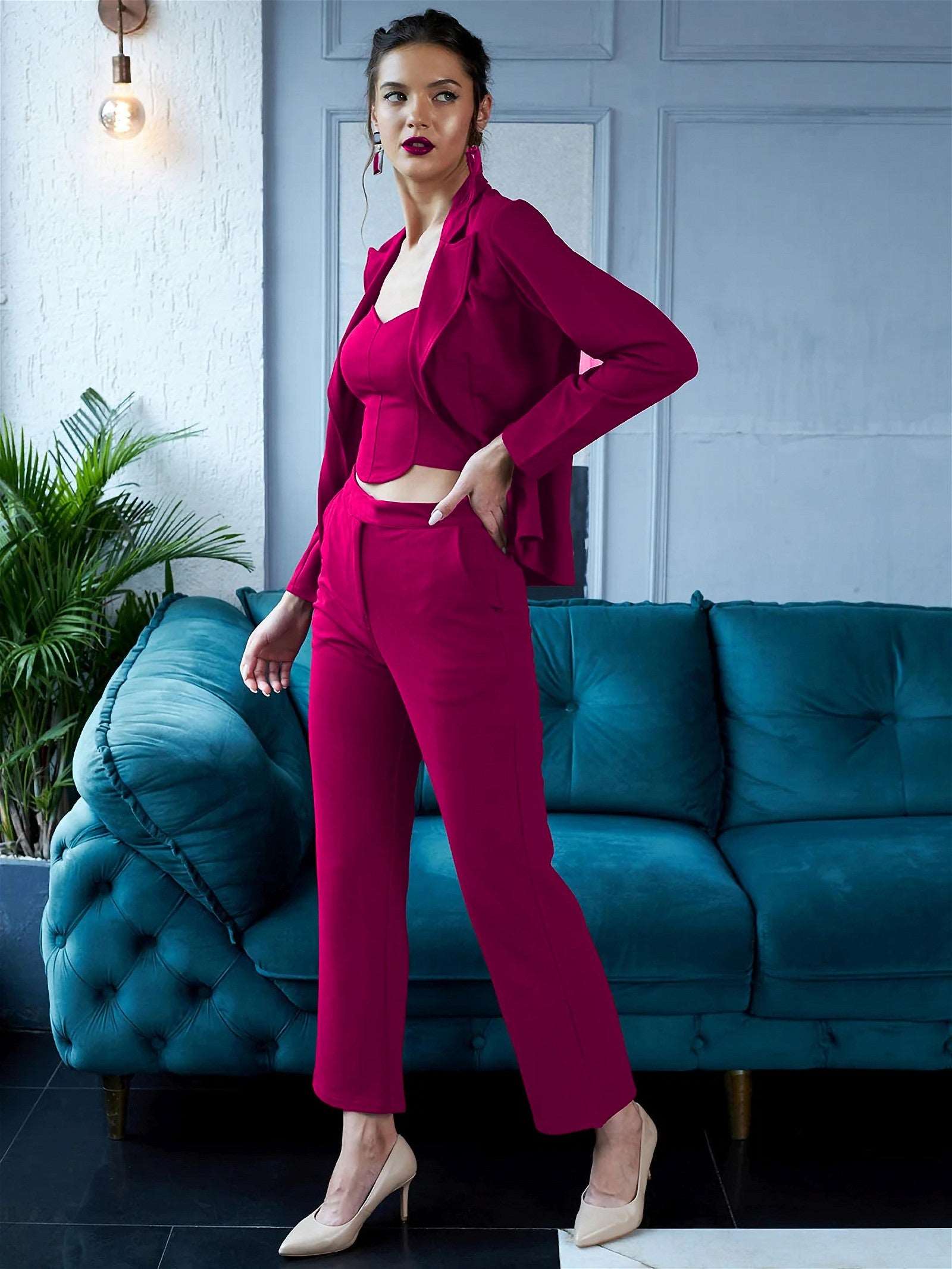 The model in the image is wearing EnVogue Chic - Hot Pink Blazer Co ord from Alice Milan. Crafted with the finest materials and impeccable attention to detail, the Formal Suit looks premium, trendy, luxurious and offers unparalleled comfort. It’s a perfect clothing option for loungewear, resort wear, party wear or for an airport look. The woman in the image looks happy, and confident with her style statement putting a happy smile on her face.