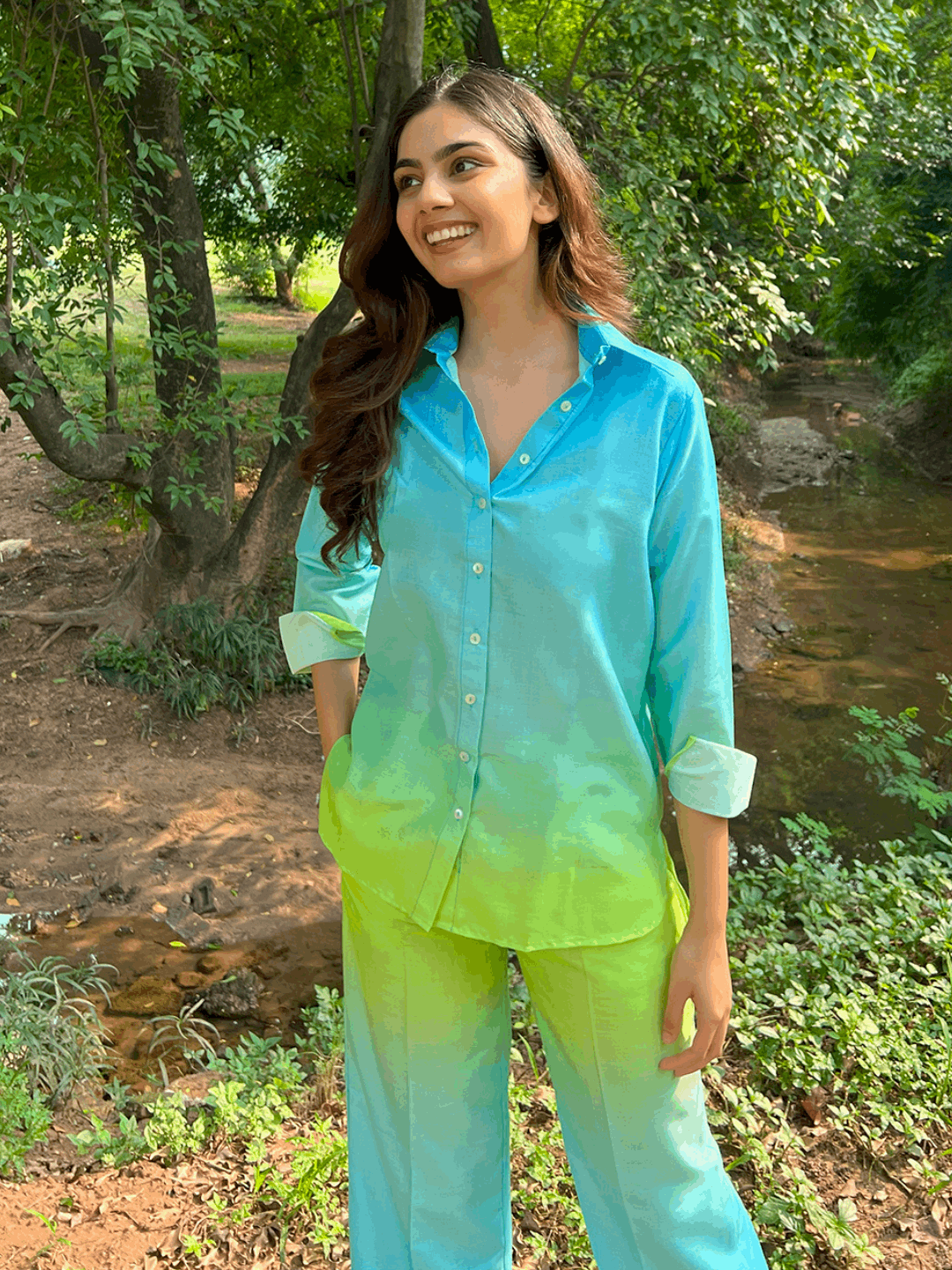 The model in the image is wearing Ombre Cotton Neon Co ord Set from Alice Milan. Crafted with the finest materials and impeccable attention to detail, the Co-ord Set looks premium, trendy, luxurious and offers unparalleled comfort. It’s a perfect clothing option for loungewear, resort wear, party wear or for an airport look. The woman in the image looks happy, and confident with her style statement putting a happy smile on her face.