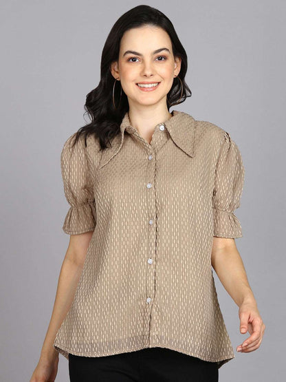 The model in the image is wearing Beige Spread Collar Shirt with Short Sleeves from Alice Milan. Crafted with the finest materials and impeccable attention to detail, the Western Wear Top looks premium, trendy, luxurious and offers unparalleled comfort. It’s a perfect clothing option for loungewear, resort wear, party wear or for an airport look. The woman in the image looks happy, and confident with her style statement putting a happy smile on her face.