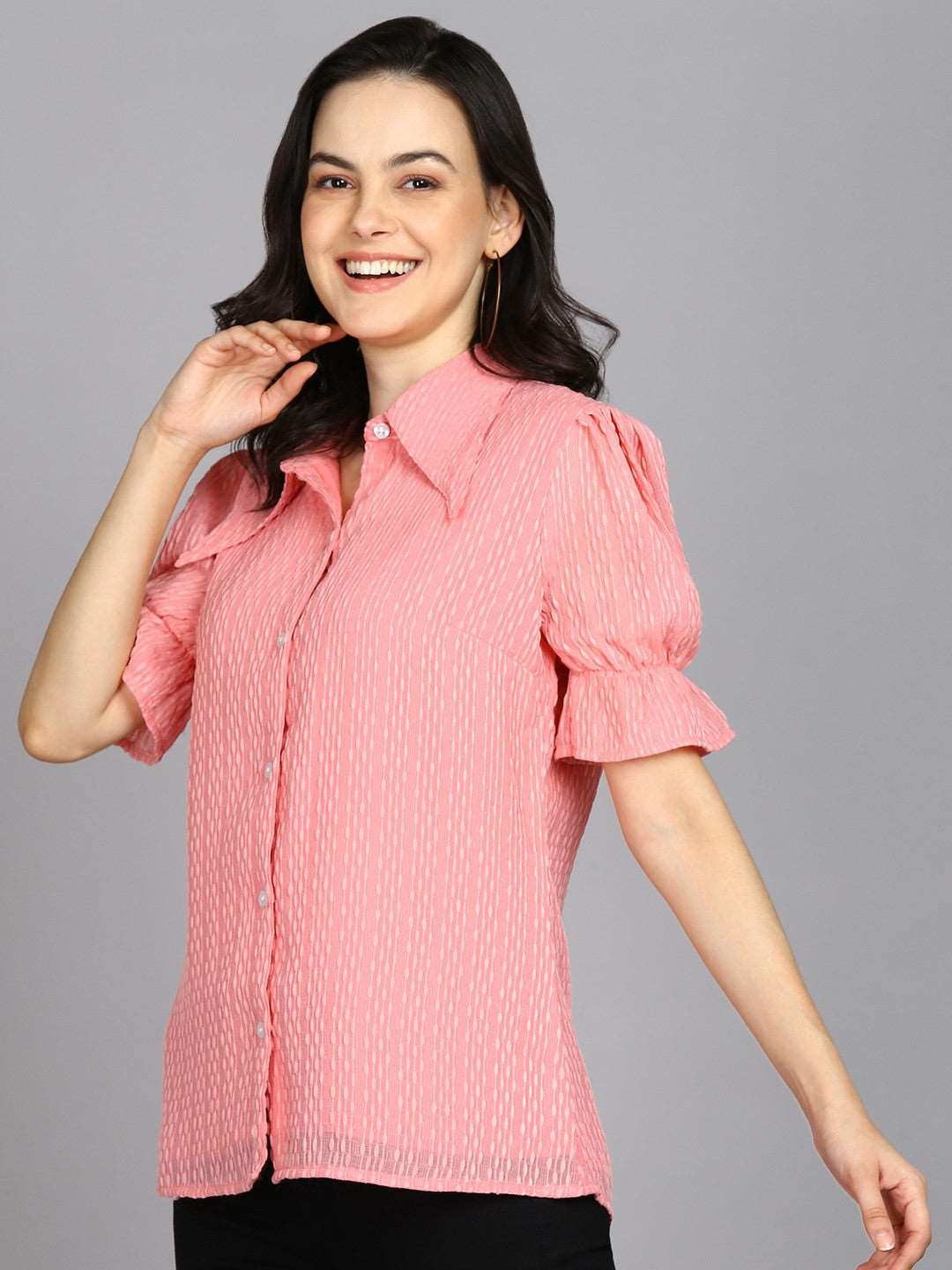 The model in the image is wearing Casual Regular Sleeves Self Design Women Pink Top from Alice Milan. Crafted with the finest materials and impeccable attention to detail, the Western Wear Top looks premium, trendy, luxurious and offers unparalleled comfort. It’s a perfect clothing option for loungewear, resort wear, party wear or for an airport look. The woman in the image looks happy, and confident with her style statement putting a happy smile on her face.