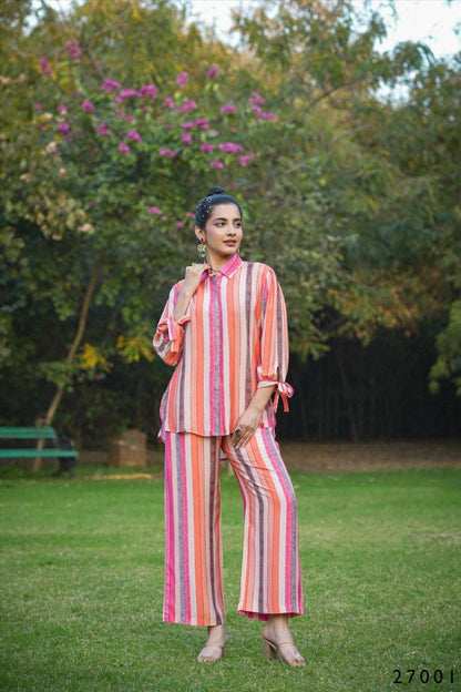 The model in the image is wearing Candy Stripes Cotton Party Co ord Set from Alice Milan. Crafted with the finest materials and impeccable attention to detail, the Co-ord Set looks premium, trendy, luxurious and offers unparalleled comfort. It’s a perfect clothing option for loungewear, resort wear, party wear or for an airport look. The woman in the image looks happy, and confident with her style statement putting a happy smile on her face.