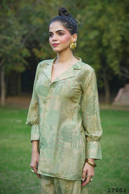 The model in the image is wearing Green Serenity Cotton Co order Dress Set from Alice Milan. Crafted with the finest materials and impeccable attention to detail, the Western Wear Top looks premium, trendy, luxurious and offers unparalleled comfort. It’s a perfect clothing option for loungewear, resort wear, party wear or for an airport look. The woman in the image looks happy, and confident with her style statement putting a happy smile on her face.
