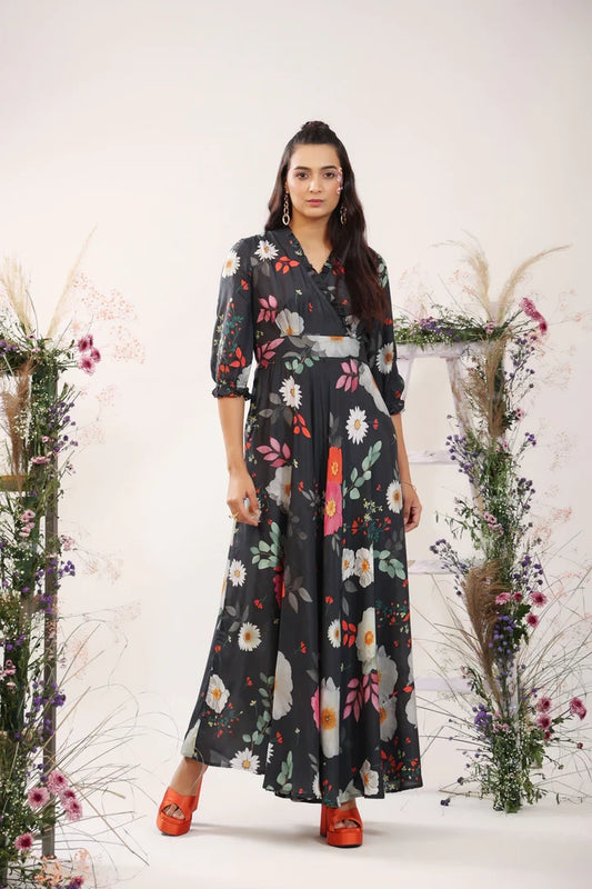 The model in the image is wearing Black Women's Floral Printed Stylish Long Party Wear Maxi Dress from Alice Milan. Crafted with the finest materials and impeccable attention to detail, the Dress looks premium, trendy, luxurious and offers unparalleled comfort. It’s a perfect clothing option for loungewear, resort wear, party wear or for an airport look. The woman in the image looks happy, and confident with her style statement putting a happy smile on her face.