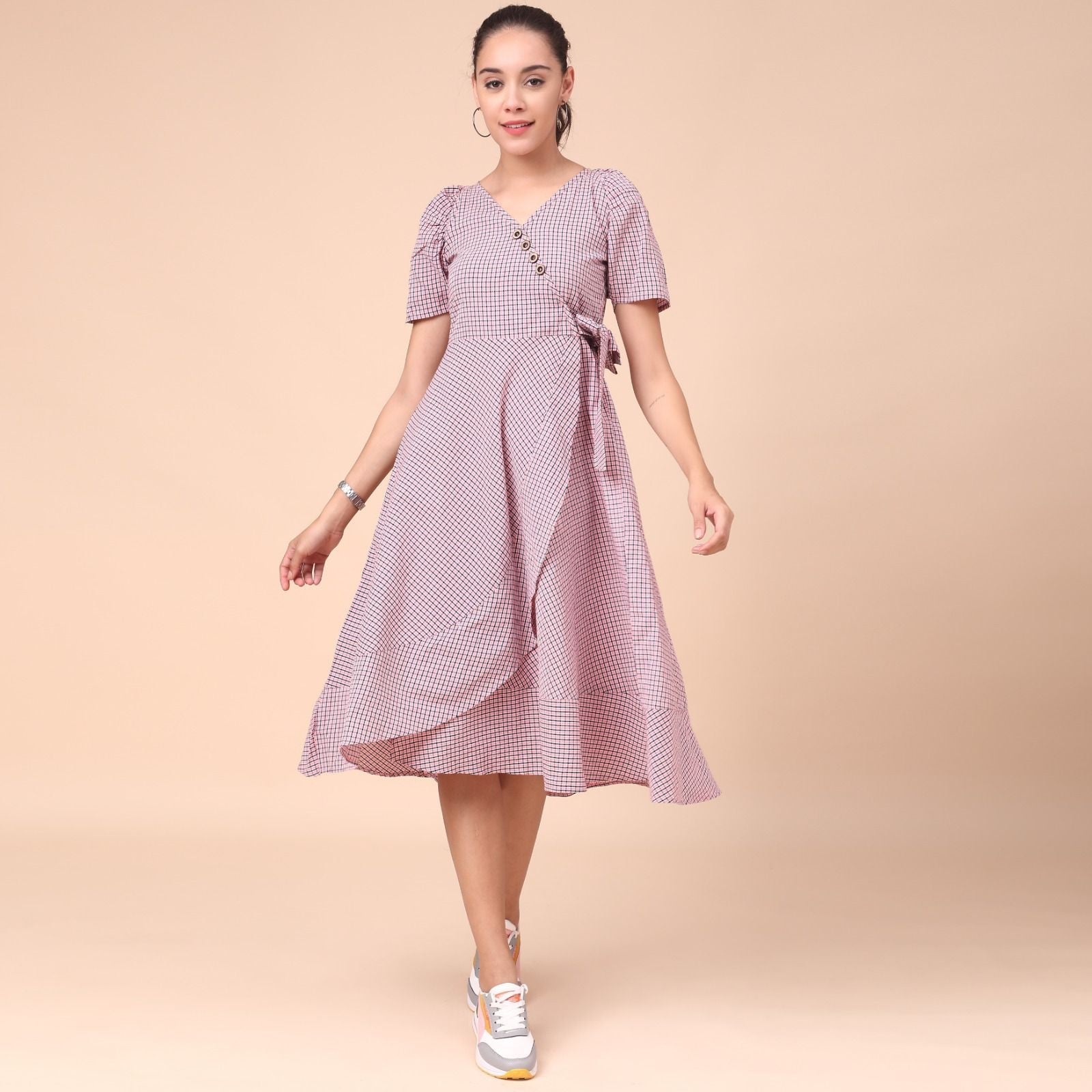 The model in the image is wearing Women's Cotton Knee Length Fit And Flare Dress from Alice Milan. Crafted with the finest materials and impeccable attention to detail, the Dress looks premium, trendy, luxurious and offers unparalleled comfort. It’s a perfect clothing option for loungewear, resort wear, party wear or for an airport look. The woman in the image looks happy, and confident with her style statement putting a happy smile on her face.