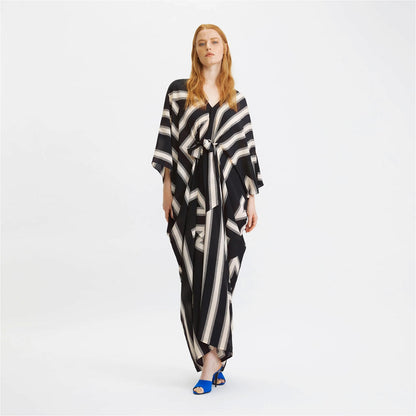 The model in the image is wearing Zebra Stripes French Moss Stylish Kaftan from Alice Milan. Crafted with the finest materials and impeccable attention to detail, the Kaftan / Dress looks premium, trendy, luxurious and offers unparalleled comfort. It’s a perfect clothing option for loungewear, resort wear, party wear or for an airport look. The woman in the image looks happy, and confident with her style statement putting a happy smile on her face.