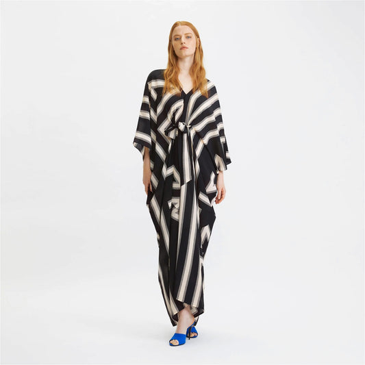 The model in the image is wearing Zebra Stripes French Moss Stylish Kaftan from Alice Milan. Crafted with the finest materials and impeccable attention to detail, the Kaftan / Dress looks premium, trendy, luxurious and offers unparalleled comfort. It’s a perfect clothing option for loungewear, resort wear, party wear or for an airport look. The woman in the image looks happy, and confident with her style statement putting a happy smile on her face.