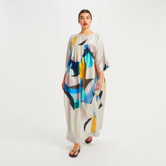 The model in the image is wearing Summer special Rayon Cotton Women Kaftan from Alice Milan. Crafted with the finest materials and impeccable attention to detail, the Kaftan / Dress looks premium, trendy, luxurious and offers unparalleled comfort. It’s a perfect clothing option for loungewear, resort wear, party wear or for an airport look. The woman in the image looks happy, and confident with her style statement putting a happy smile on her face.