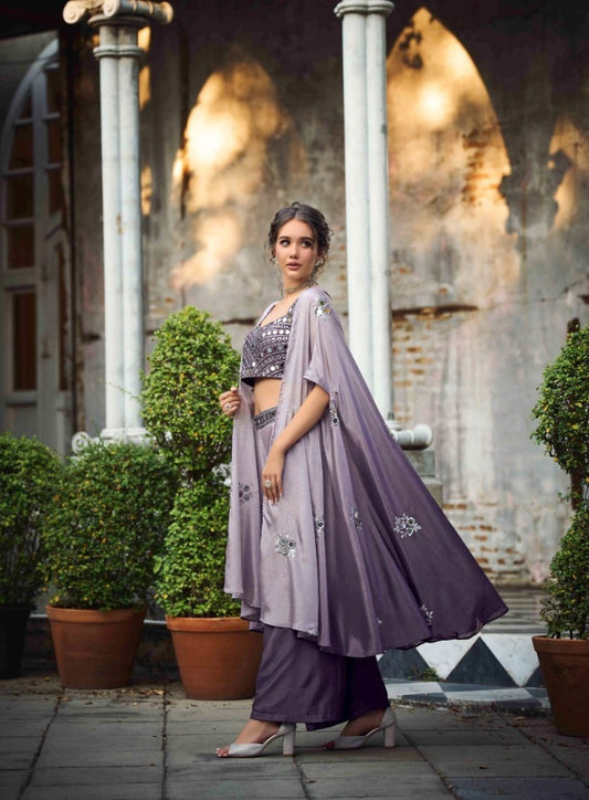 The model in the image is wearing Purple Classy Indo Western With Stylish Koti from Alice Milan. Crafted with the finest materials and impeccable attention to detail, the  looks premium, trendy, luxurious and offers unparalleled comfort. It’s a perfect clothing option for loungewear, resort wear, party wear or for an airport look. The woman in the image looks happy, and confident with her style statement putting a happy smile on her face.