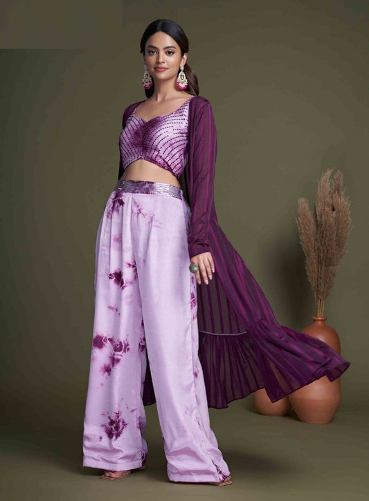 The model in the image is wearing Dark Purple Stylish Indo Western For Women from Alice Milan. Crafted with the finest materials and impeccable attention to detail, the  looks premium, trendy, luxurious and offers unparalleled comfort. It’s a perfect clothing option for loungewear, resort wear, party wear or for an airport look. The woman in the image looks happy, and confident with her style statement putting a happy smile on her face.
