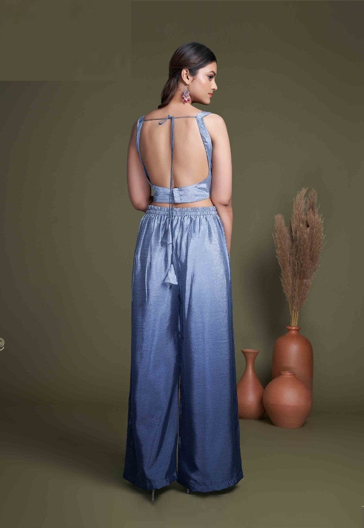 The model in the image is wearing Navy Blue Classy Indo Western With Stylish Koti from Alice Milan. Crafted with the finest materials and impeccable attention to detail, the  looks premium, trendy, luxurious and offers unparalleled comfort. It’s a perfect clothing option for loungewear, resort wear, party wear or for an airport look. The woman in the image looks happy, and confident with her style statement putting a happy smile on her face.