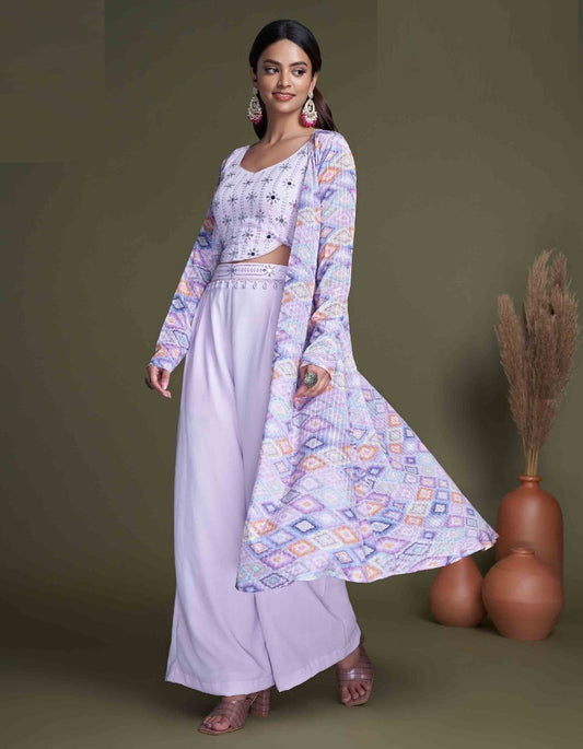 The model in the image is wearing Pastel Purple Classy Indo Western With Stylish Koti from Alice Milan. Crafted with the finest materials and impeccable attention to detail, the  looks premium, trendy, luxurious and offers unparalleled comfort. It’s a perfect clothing option for loungewear, resort wear, party wear or for an airport look. The woman in the image looks happy, and confident with her style statement putting a happy smile on her face.