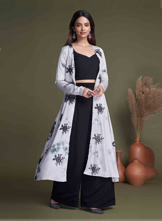 The model in the image is wearing Black And White Classy Indo Western With Stylish Koti from Alice Milan. Crafted with the finest materials and impeccable attention to detail, the  looks premium, trendy, luxurious and offers unparalleled comfort. It’s a perfect clothing option for loungewear, resort wear, party wear or for an airport look. The woman in the image looks happy, and confident with her style statement putting a happy smile on her face.