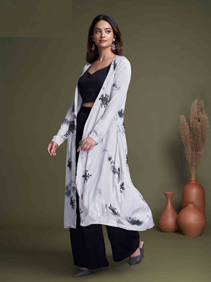 The model in the image is wearing Black And White Classy Indo Western With Stylish Koti from Alice Milan. Crafted with the finest materials and impeccable attention to detail, the  looks premium, trendy, luxurious and offers unparalleled comfort. It’s a perfect clothing option for loungewear, resort wear, party wear or for an airport look. The woman in the image looks happy, and confident with her style statement putting a happy smile on her face.