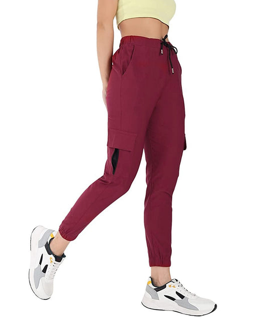 The model in the image is wearing Wine Double Pocket Corgo Pant from Alice Milan. Crafted with the finest materials and impeccable attention to detail, the Cargo Pant looks premium, trendy, luxurious and offers unparalleled comfort. It’s a perfect clothing option for loungewear, resort wear, party wear or for an airport look. The woman in the image looks happy, and confident with her style statement putting a happy smile on her face.