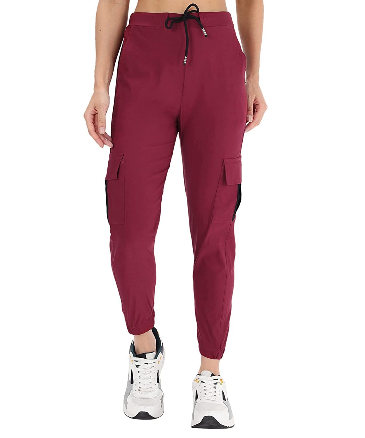 The model in the image is wearing Wine Double Pocket Corgo Pant from Alice Milan. Crafted with the finest materials and impeccable attention to detail, the Cargo Pant looks premium, trendy, luxurious and offers unparalleled comfort. It’s a perfect clothing option for loungewear, resort wear, party wear or for an airport look. The woman in the image looks happy, and confident with her style statement putting a happy smile on her face.