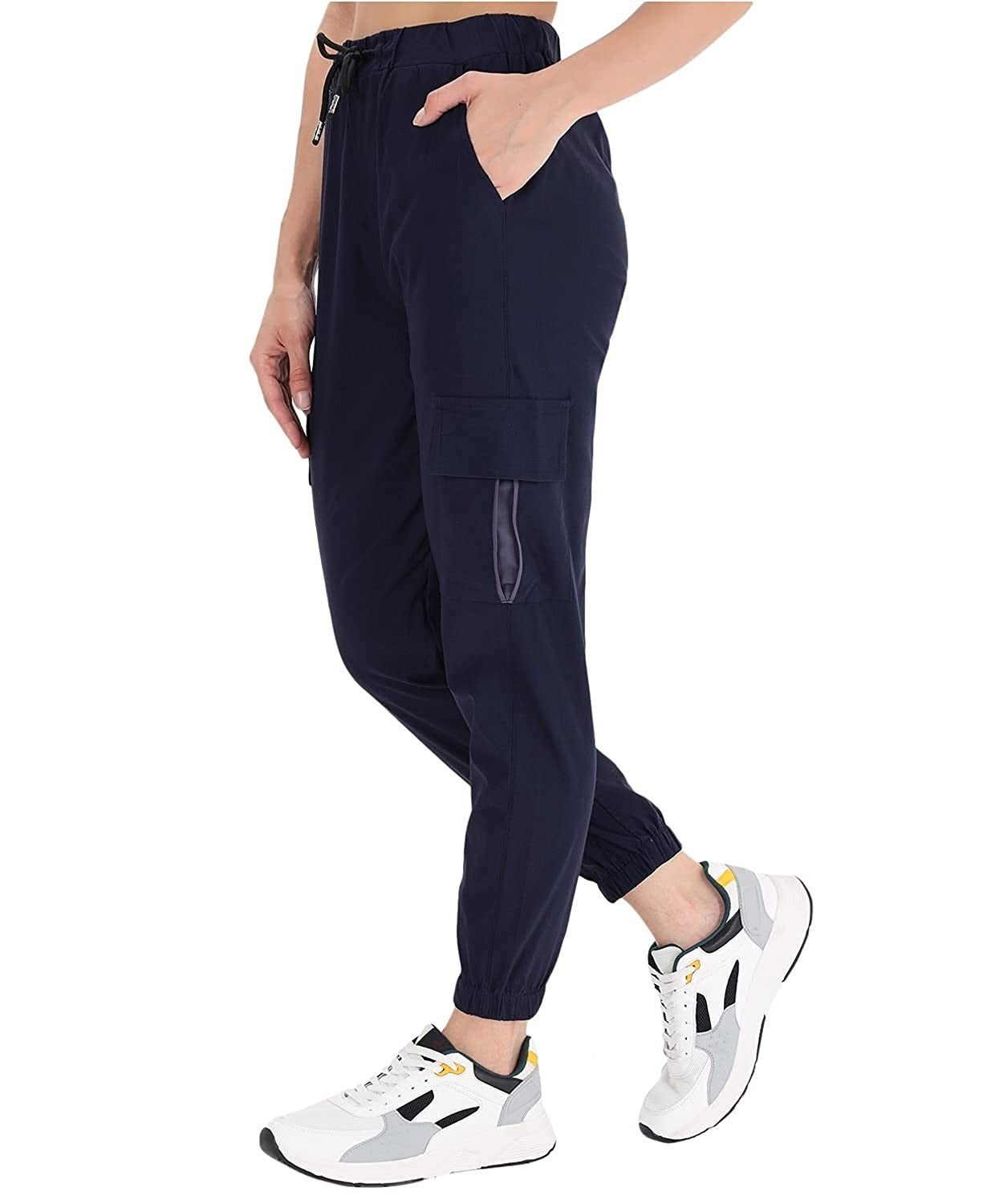 The model in the image is wearing Pant Blue Double Pocket Corgo Pant from Alice Milan. Crafted with the finest materials and impeccable attention to detail, the Cargo Pant looks premium, trendy, luxurious and offers unparalleled comfort. It’s a perfect clothing option for loungewear, resort wear, party wear or for an airport look. The woman in the image looks happy, and confident with her style statement putting a happy smile on her face.