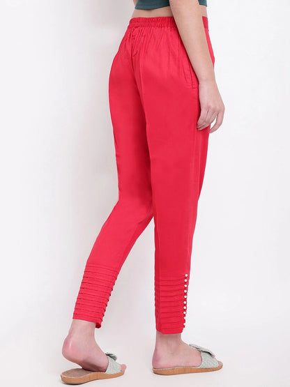 The model in the image is wearing Red Pintex Silk Women's Pant from Alice Milan. Crafted with the finest materials and impeccable attention to detail, the Women's Pant looks premium, trendy, luxurious and offers unparalleled comfort. It’s a perfect clothing option for loungewear, resort wear, party wear or for an airport look. The woman in the image looks happy, and confident with her style statement putting a happy smile on her face.