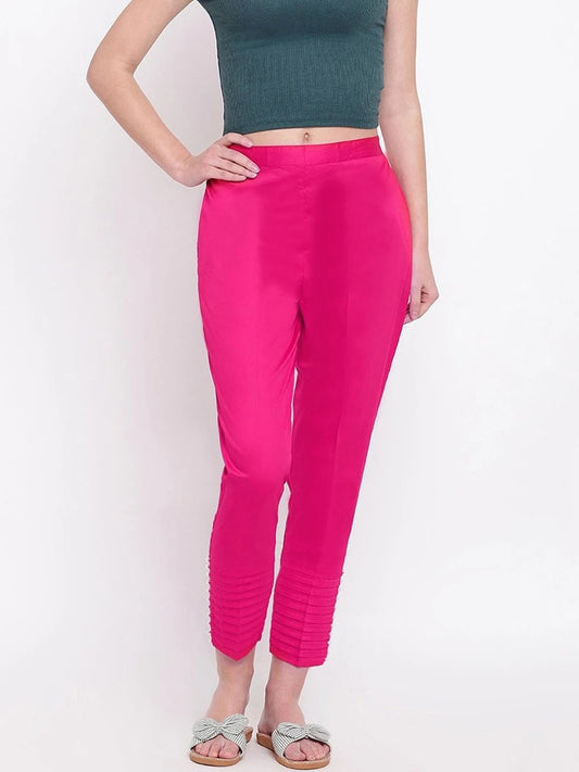 The model in the image is wearing Dark Pink Pintex Silk Women's Pant from Alice Milan. Crafted with the finest materials and impeccable attention to detail, the Women's Pant looks premium, trendy, luxurious and offers unparalleled comfort. It’s a perfect clothing option for loungewear, resort wear, party wear or for an airport look. The woman in the image looks happy, and confident with her style statement putting a happy smile on her face.