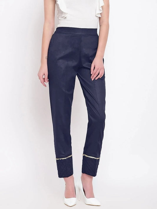 The model in the image is wearing Navy Blue Pant For Women from Alice Milan. Crafted with the finest materials and impeccable attention to detail, the Women's Pant looks premium, trendy, luxurious and offers unparalleled comfort. It’s a perfect clothing option for loungewear, resort wear, party wear or for an airport look. The woman in the image looks happy, and confident with her style statement putting a happy smile on her face.