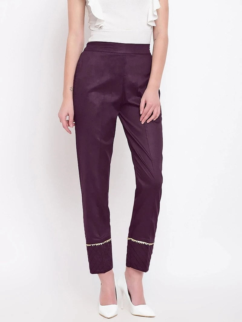 The model in the image is wearing Purple Pant For Women from Alice Milan. Crafted with the finest materials and impeccable attention to detail, the Women's Pant looks premium, trendy, luxurious and offers unparalleled comfort. It’s a perfect clothing option for loungewear, resort wear, party wear or for an airport look. The woman in the image looks happy, and confident with her style statement putting a happy smile on her face.