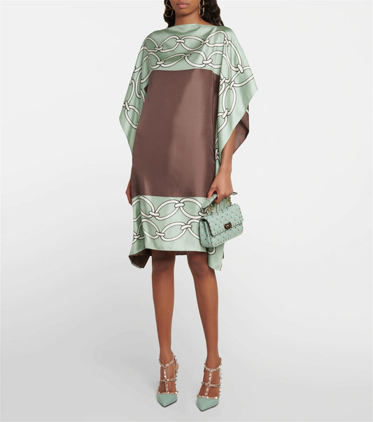The model in the image is wearing Green Colour Printed Satin Silk Casual Wear Kaftan from Alice Milan. Crafted with the finest materials and impeccable attention to detail, the Kaftan / Dress looks premium, trendy, luxurious and offers unparalleled comfort. It’s a perfect clothing option for loungewear, resort wear, party wear or for an airport look. The woman in the image looks happy, and confident with her style statement putting a happy smile on her face.