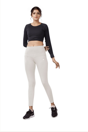The model in the image is wearing White Colour Polyester Solid Pattern Track Pant For Women's from Alice Milan. Crafted with the finest materials and impeccable attention to detail, the Track Pant looks premium, trendy, luxurious and offers unparalleled comfort. It’s a perfect clothing option for loungewear, resort wear, party wear or for an airport look. The woman in the image looks happy, and confident with her style statement putting a happy smile on her face.