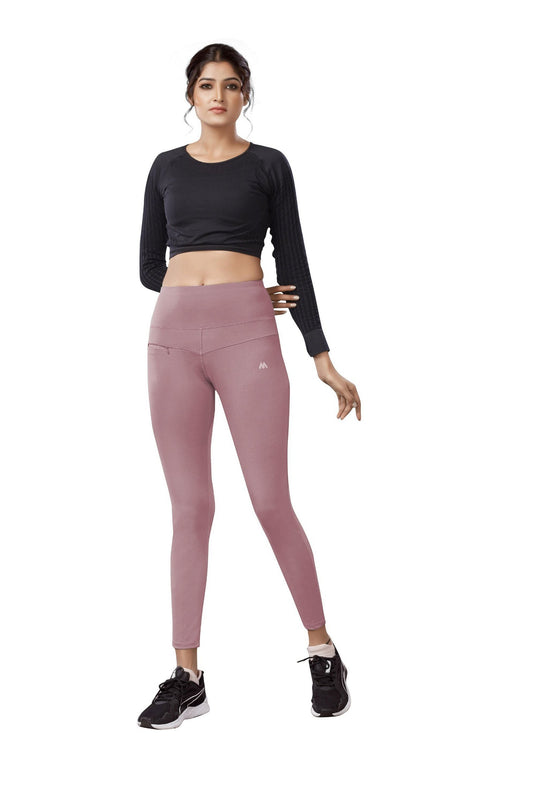 The model in the image is wearing Pink Colour Polyester Solid Pattern Track Pant For Women's from Alice Milan. Crafted with the finest materials and impeccable attention to detail, the Track Pant looks premium, trendy, luxurious and offers unparalleled comfort. It’s a perfect clothing option for loungewear, resort wear, party wear or for an airport look. The woman in the image looks happy, and confident with her style statement putting a happy smile on her face.