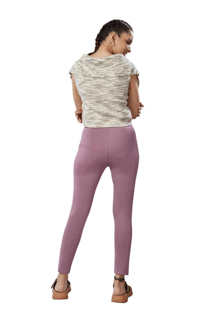 The model in the image is wearing Pink Colour Polyester Solid Pattern Track Pant For Women's from Alice Milan. Crafted with the finest materials and impeccable attention to detail, the Track Pant looks premium, trendy, luxurious and offers unparalleled comfort. It’s a perfect clothing option for loungewear, resort wear, party wear or for an airport look. The woman in the image looks happy, and confident with her style statement putting a happy smile on her face.
