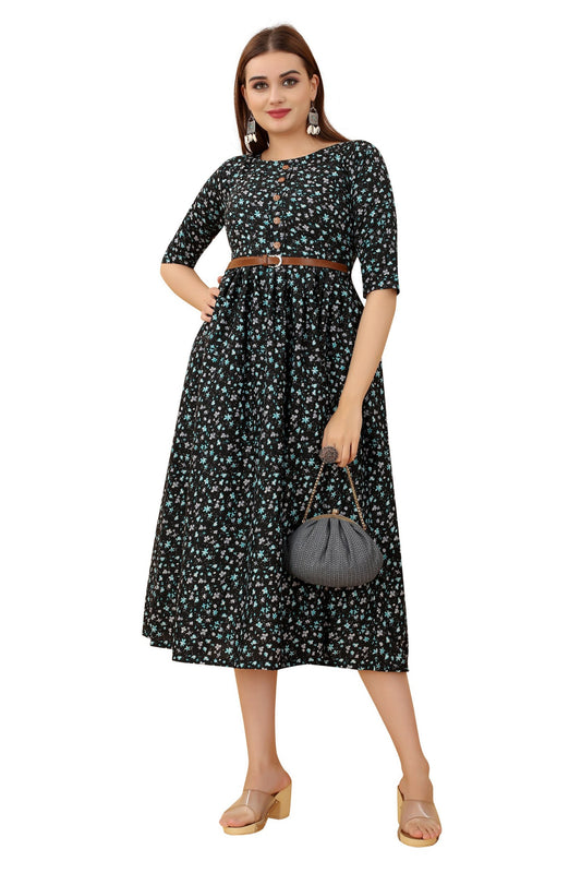 The model in the image is wearing Women's Black Colour Crepe Printed Casual Wear Dress from Alice Milan. Crafted with the finest materials and impeccable attention to detail, the Dress looks premium, trendy, luxurious and offers unparalleled comfort. It’s a perfect clothing option for loungewear, resort wear, party wear or for an airport look. The woman in the image looks happy, and confident with her style statement putting a happy smile on her face.