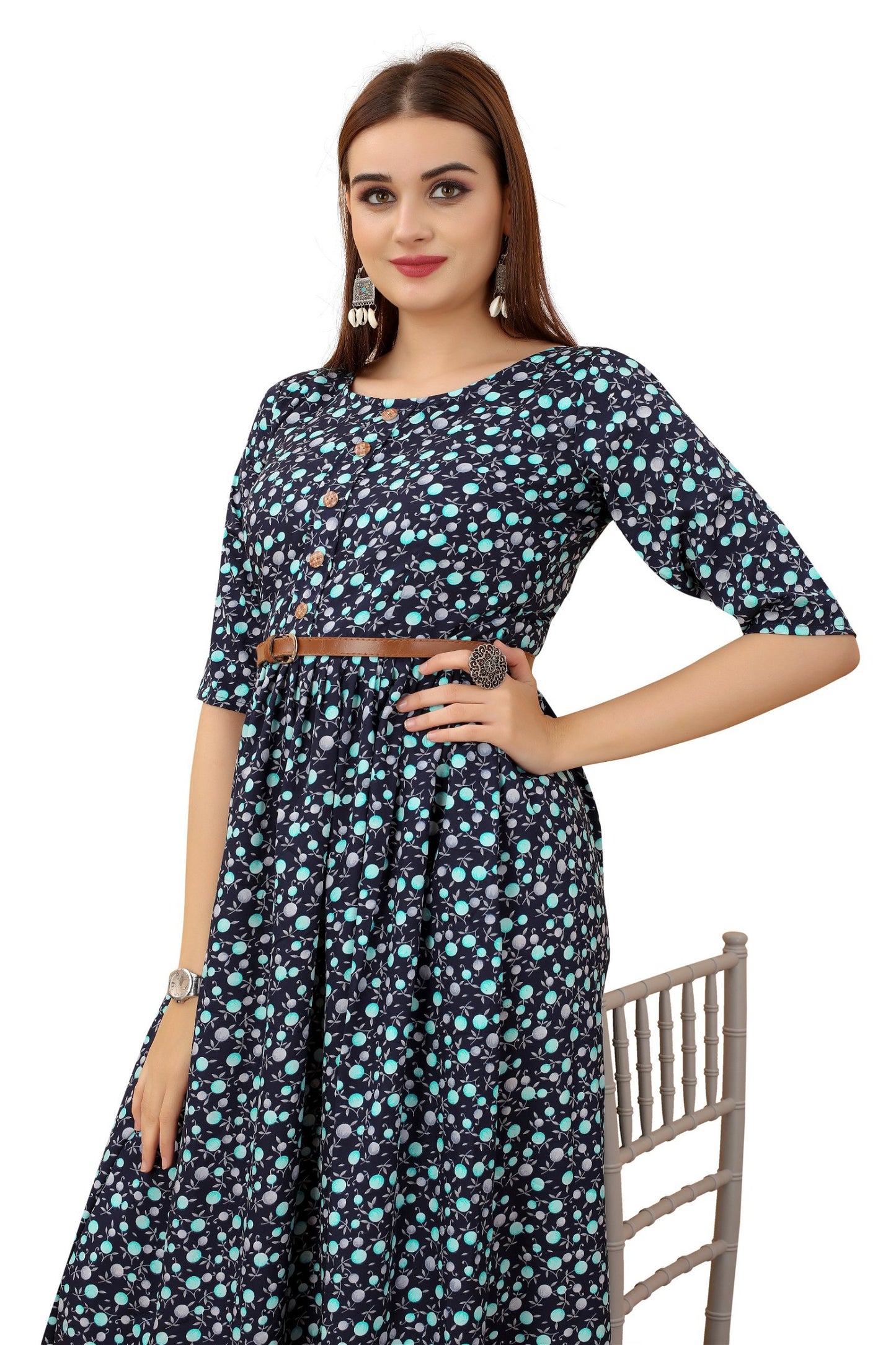 The model in the image is wearing Women's Navy Blue Colour Crepe Printed Casual Wear Dress from Alice Milan. Crafted with the finest materials and impeccable attention to detail, the Dress looks premium, trendy, luxurious and offers unparalleled comfort. It’s a perfect clothing option for loungewear, resort wear, party wear or for an airport look. The woman in the image looks happy, and confident with her style statement putting a happy smile on her face.