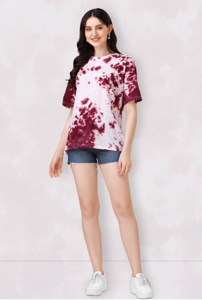 The model in the image is wearing Round Neck Tie & Dye Regular Tshirt For Women from Alice Milan. Crafted with the finest materials and impeccable attention to detail, the Western Wear Top looks premium, trendy, luxurious and offers unparalleled comfort. It’s a perfect clothing option for loungewear, resort wear, party wear or for an airport look. The woman in the image looks happy, and confident with her style statement putting a happy smile on her face.