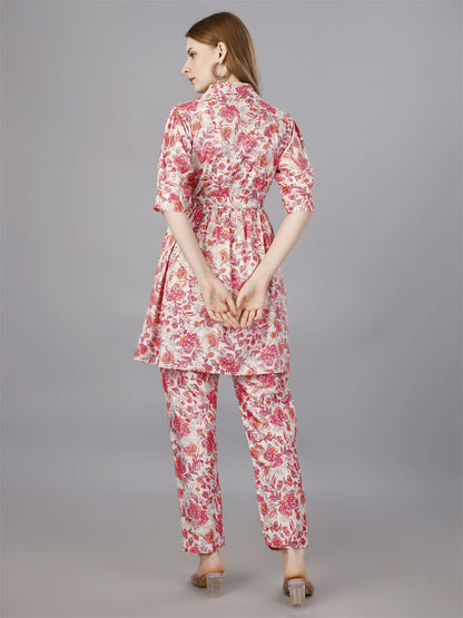 The model in the image is wearing Printed pink 2-Piece Shirt & Trousers Set from Alice Milan. Crafted with the finest materials and impeccable attention to detail, the  looks premium, trendy, luxurious and offers unparalleled comfort. It’s a perfect clothing option for loungewear, resort wear, party wear or for an airport look. The woman in the image looks happy, and confident with her style statement putting a happy smile on her face.
