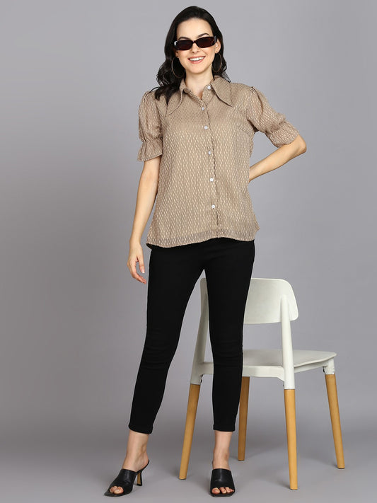 The model in the image is wearing Beige Spread Collar Shirt with Short Sleeves from Alice Milan. Crafted with the finest materials and impeccable attention to detail, the Western Wear Top looks premium, trendy, luxurious and offers unparalleled comfort. It’s a perfect clothing option for loungewear, resort wear, party wear or for an airport look. The woman in the image looks happy, and confident with her style statement putting a happy smile on her face.