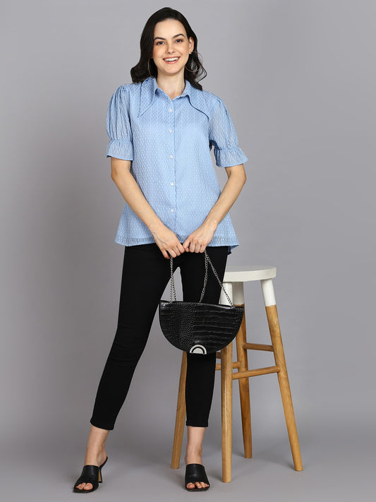 The model in the image is wearing Casual Regular Sleeves Self Design Women Sky Blue Top from Alice Milan. Crafted with the finest materials and impeccable attention to detail, the Western Wear Top looks premium, trendy, luxurious and offers unparalleled comfort. It’s a perfect clothing option for loungewear, resort wear, party wear or for an airport look. The woman in the image looks happy, and confident with her style statement putting a happy smile on her face.