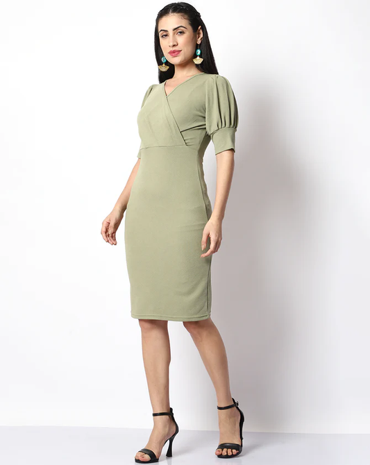 The model in the image is wearing Casual Solid Women Green V-Neck Bodycon from Alice Milan. Crafted with the finest materials and impeccable attention to detail, the Dress looks premium, trendy, luxurious and offers unparalleled comfort. It’s a perfect clothing option for loungewear, resort wear, party wear or for an airport look. The woman in the image looks happy, and confident with her style statement putting a happy smile on her face.