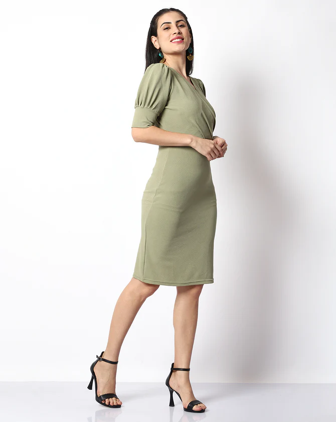 The model in the image is wearing Casual Solid Women Green V-Neck Bodycon from Alice Milan. Crafted with the finest materials and impeccable attention to detail, the Dress looks premium, trendy, luxurious and offers unparalleled comfort. It’s a perfect clothing option for loungewear, resort wear, party wear or for an airport look. The woman in the image looks happy, and confident with her style statement putting a happy smile on her face.