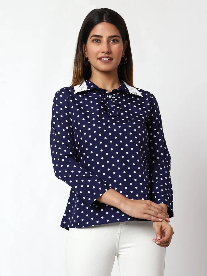 The model in the image is wearing Casual Printed Women Dark Blue Round Neck Top from Alice Milan. Crafted with the finest materials and impeccable attention to detail, the Western Wear Top looks premium, trendy, luxurious and offers unparalleled comfort. It’s a perfect clothing option for loungewear, resort wear, party wear or for an airport look. The woman in the image looks happy, and confident with her style statement putting a happy smile on her face.