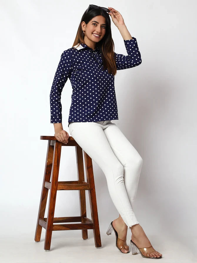 The model in the image is wearing Casual Printed Women Dark Blue Round Neck Top from Alice Milan. Crafted with the finest materials and impeccable attention to detail, the Western Wear Top looks premium, trendy, luxurious and offers unparalleled comfort. It’s a perfect clothing option for loungewear, resort wear, party wear or for an airport look. The woman in the image looks happy, and confident with her style statement putting a happy smile on her face.