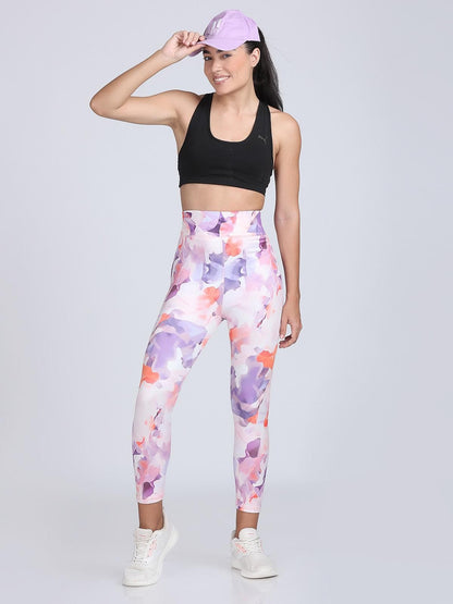 The model in the image is wearing BlossomFit Leggings from Alice Milan. Crafted with the finest materials and impeccable attention to detail, the Leggings looks premium, trendy, luxurious and offers unparalleled comfort. It’s a perfect clothing option for loungewear, resort wear, party wear or for an airport look. The woman in the image looks happy, and confident with her style statement putting a happy smile on her face.